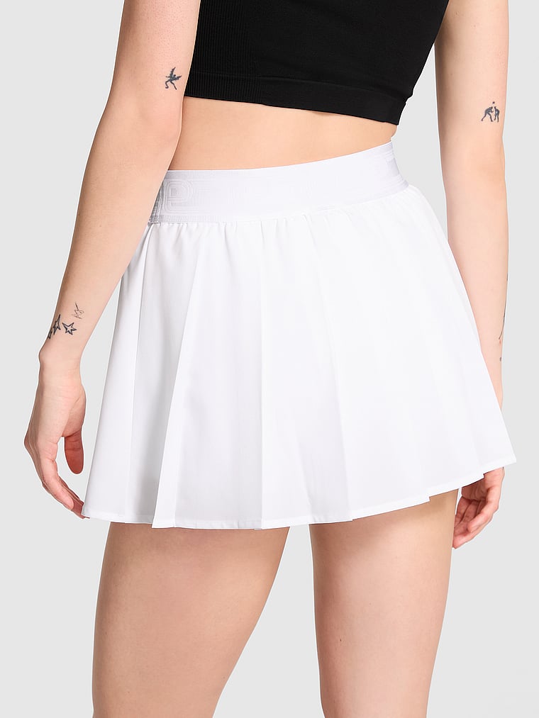 PINK Tech Stretch Pleated Tennis Skort, White/Ivory, onModelBack, 2 of 4 Sofia is 5'10" and wears Small